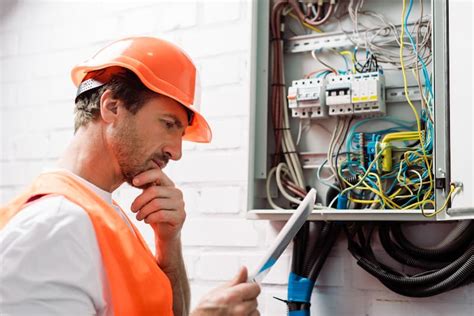 Electrician troubleshooting an electrical system