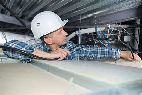 Electrician working in a tight space