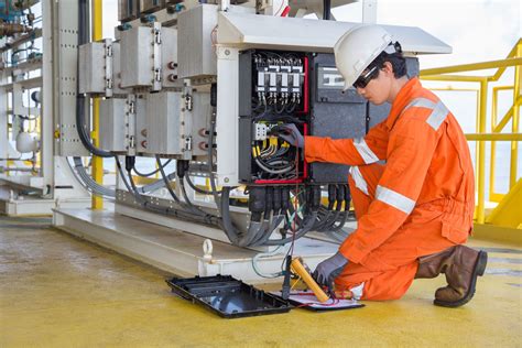 Electricians performing maintenance tasks in a power plant