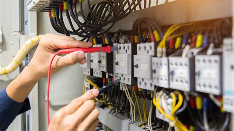 Electricians working with electrical systems in a power plant