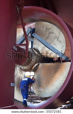 Engineer on a boat inspecting a propeller