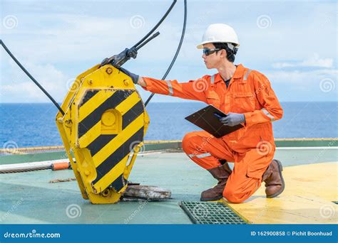 Engineer on a boat inspecting equipment