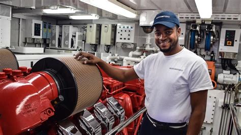 Engineer on a boat repairing a generator