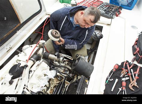 Engineer on a boat repairing a pump