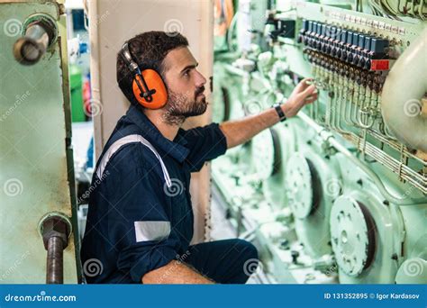 Engineer on a boat working in a crowded engine room