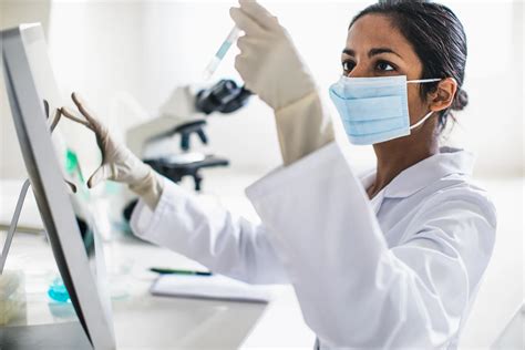 An epidemiologist analyzing data on a computer