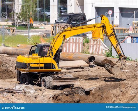 An excavator digging a foundation on a construction site