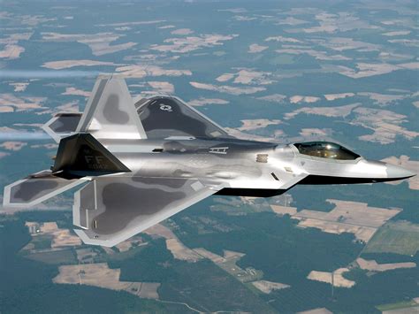 F-22 Raptor in flight over a landscape