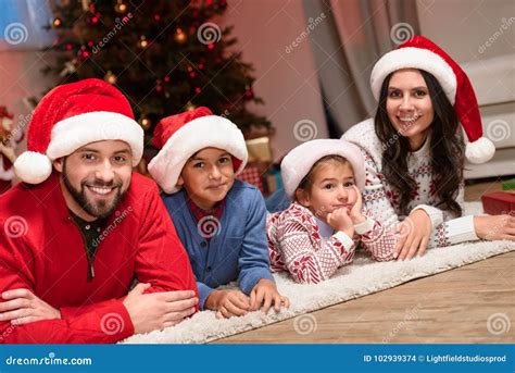 Family wearing festive Santa hats for a holiday portrait