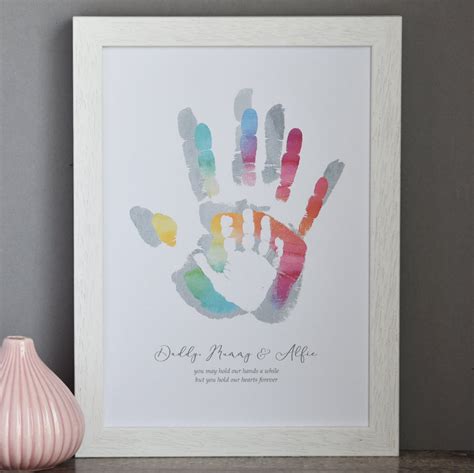 A father and child creating handprint art