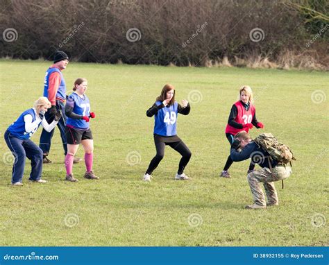 Female boot camp participant exercising with a kettlebell