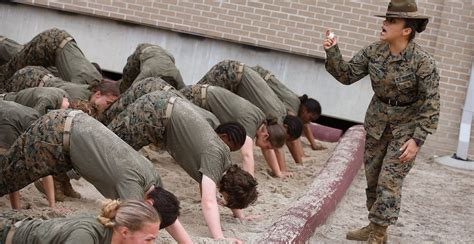 Female boot camp participant exercising with a kettlebell