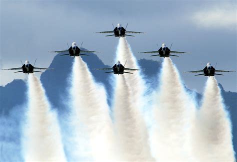 A formation of fighter jets taking off from a runway