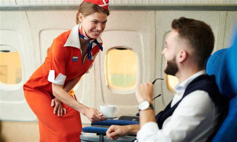 Flight attendant serving a passenger