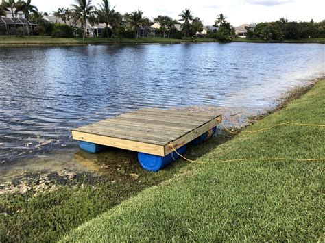 A floating dock with barrels