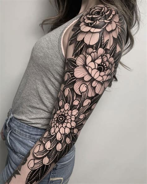 Floral arm sleeve tattoos with vibrant colors