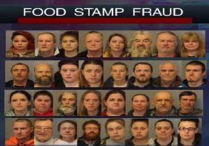 A person holding a food stamp card, with a blurred background of a grocery store