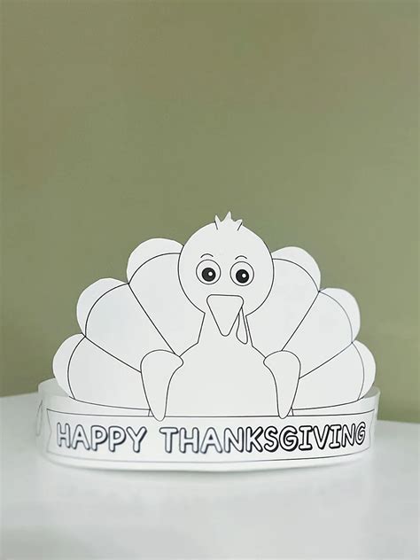 A child holding a free turkey hat printable