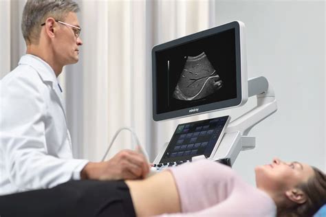 Sonographer using advanced ultrasound equipment