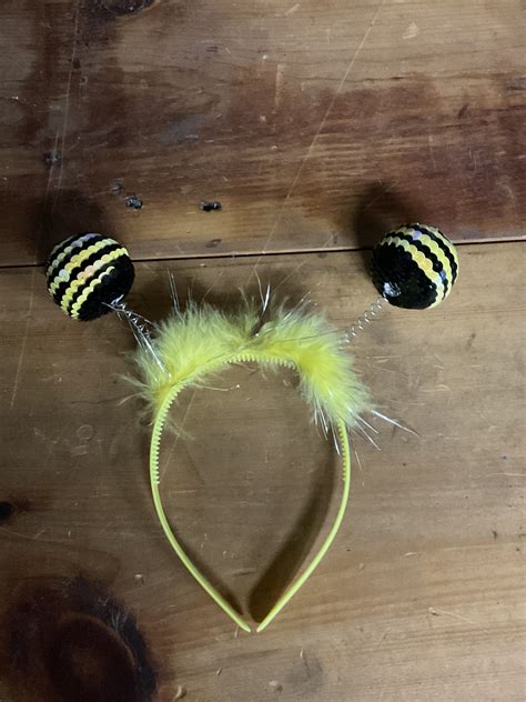 A person wearing a garden bee headband