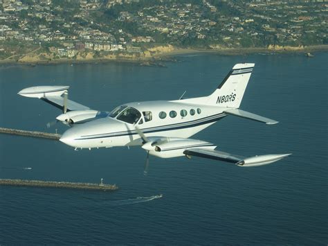 Gary Allan standing in front of his Cessna 421, with a proud smile