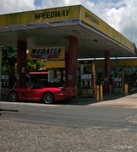 A gas station with fuel pumps and a convenience store