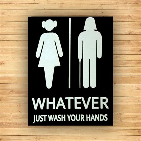 A person holding a tablet with a printable template for a gender-neutral bathroom sign