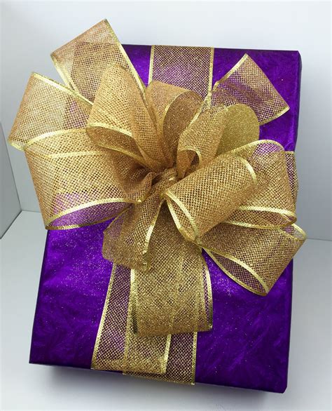 A beautifully wrapped gift adorned with a delicate gold bow