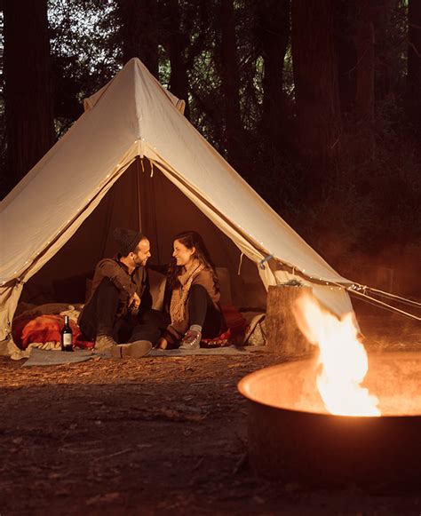 A couple enjoying a romantic glamping getaway