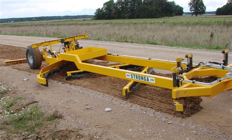 A grader grading a road on a construction site