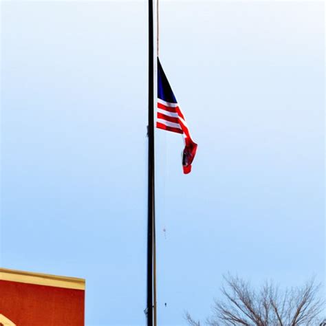 A flagpole with a flag flying at half-mast