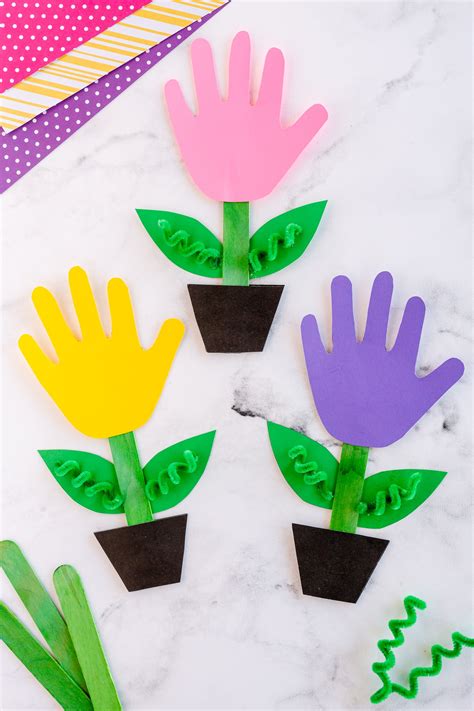 A handprint art template featuring a colorful flower