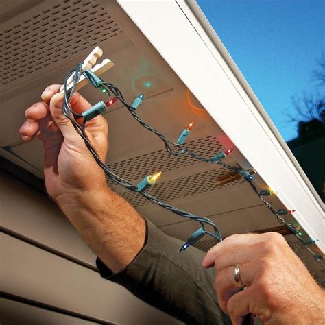 A handyman working on a Christmas light installation