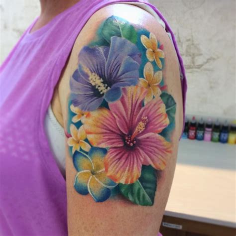 A tattoo of a Hawaiian flower arrangement on the chest