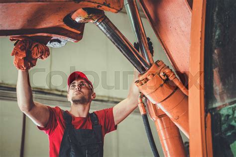 Heavy machinery mechanic repairing equipment