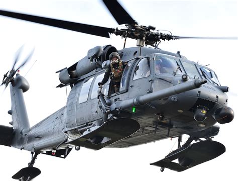 HH-60 Pave Hawk flying over a forest landscape