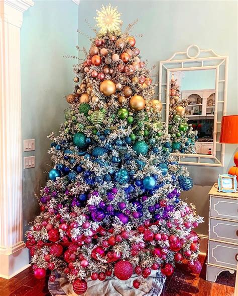 A winter wonderland-themed tree with snowflakes, pinecones, and blue ornaments