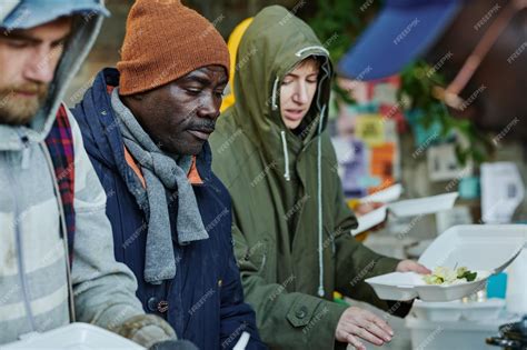 Homeless individuals eating a meal at a shelter