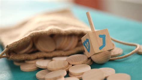 A child holding a homemade dreidel