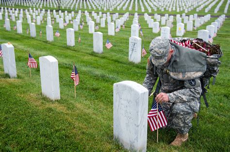 A military funeral procession, with soldiers carrying the American flag