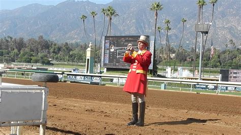 A bugler playing a call to post at a horse racing event