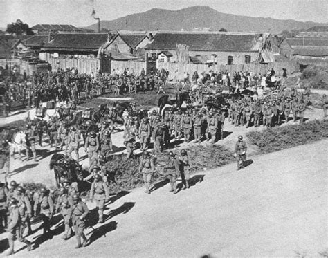 Japanese troops marching through the streets of Mukden in 1931