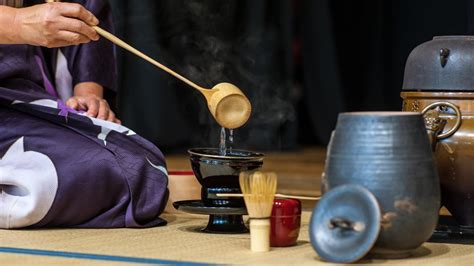 A person preparing tea in a traditional Japanese setting