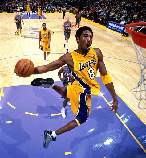 Kobe Bryant holding his NBA championship trophies