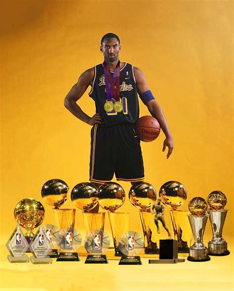 Kobe Bryant holding his NBA championship trophies