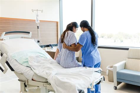 Labor and delivery nurse assisting with an induction