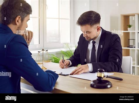 A lawyer meeting with a client in a conference room