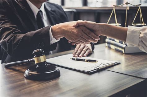 A lawyer speaking with a client in a conference room