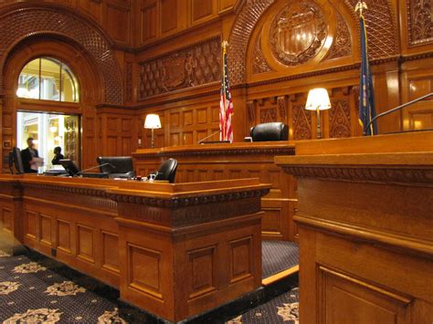 A lawyer standing in a courtroom, addressing a judge