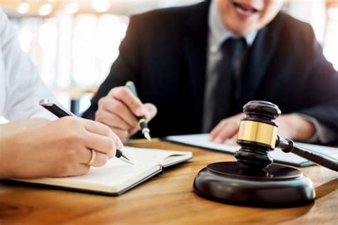 A lawyer sitting across from an opposing counsel, negotiating a settlement